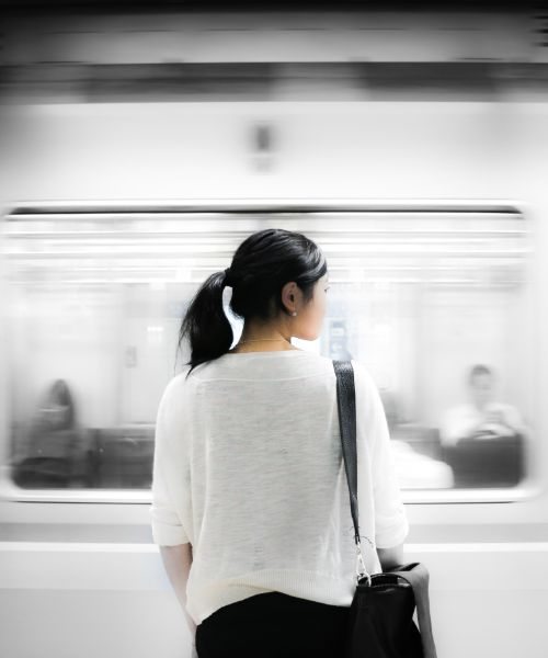 A girl and a train passing.